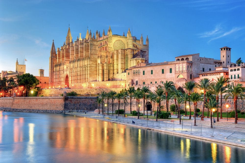 Cathedral of Palma de Majorca reflecting on the water at evening